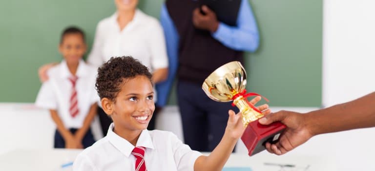 Student in Uniform gets Trophy-min