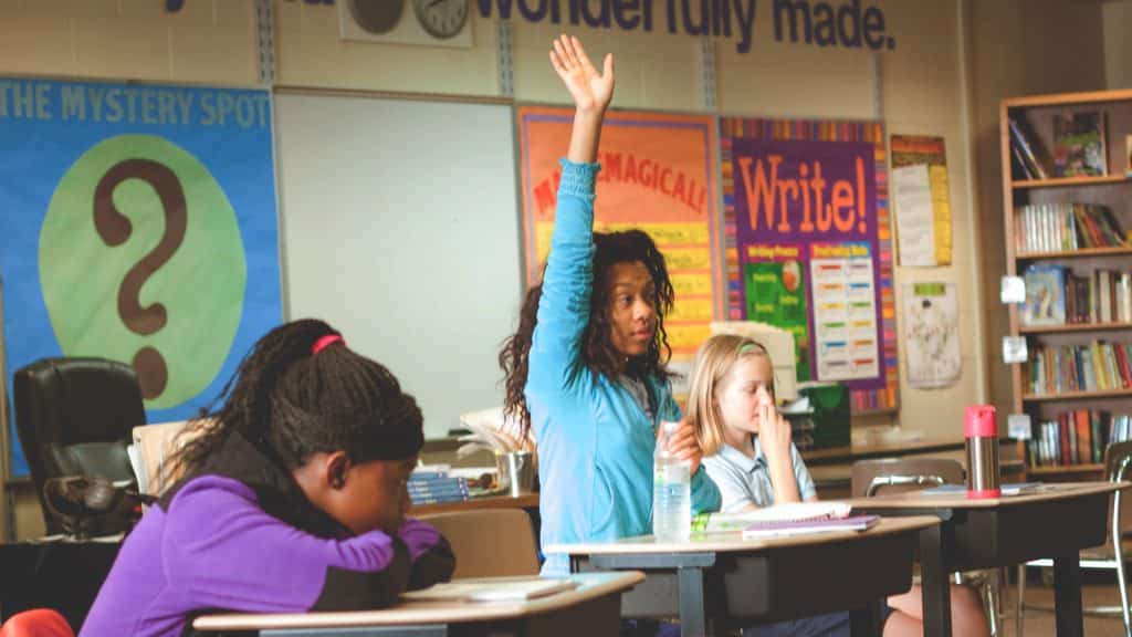 Why are students skilled in debate more likely to enter top universities?