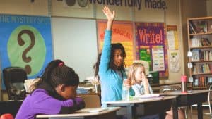 Why are students skilled in debate more likely to enter top universities?
